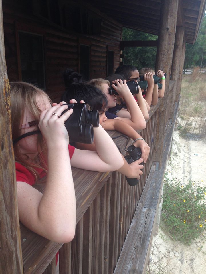 Students look through binoculars at Oakland Nature Preserve 