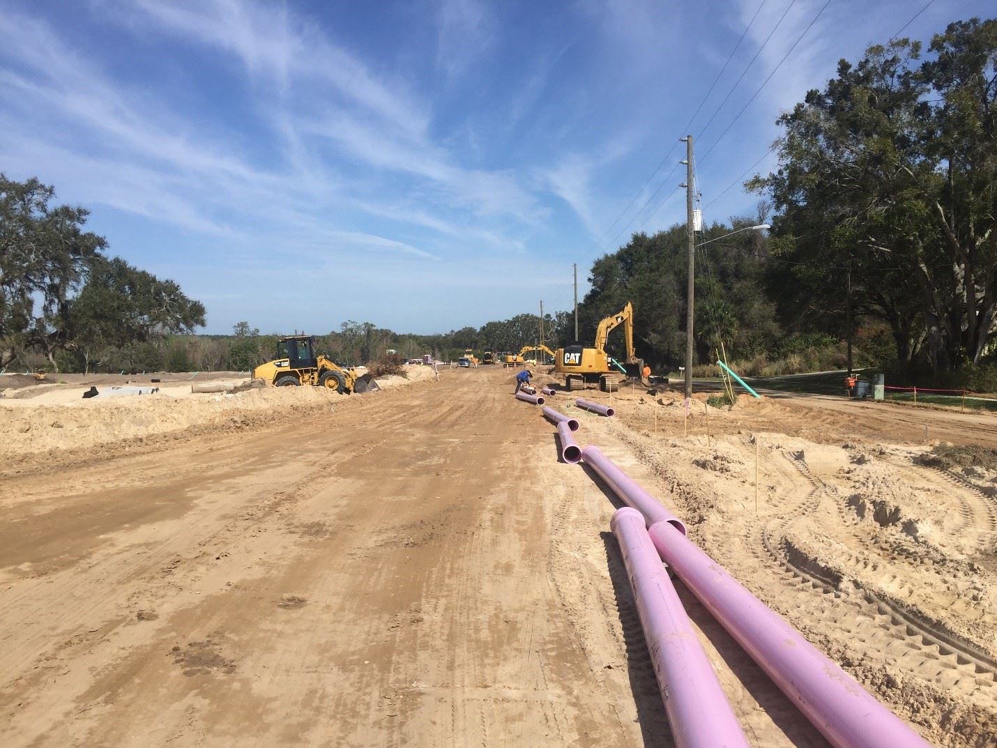 Dirt road being prepped for sanitary sewer piping installation.