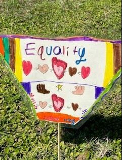A close up of student artwork with work Equality.  