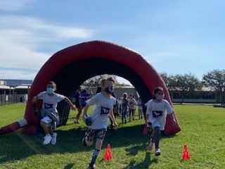 Several students running through the Boosterthon tunnel. 